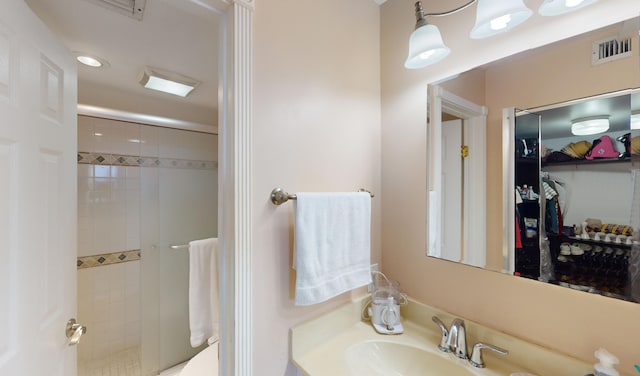 bathroom featuring sink and an enclosed shower