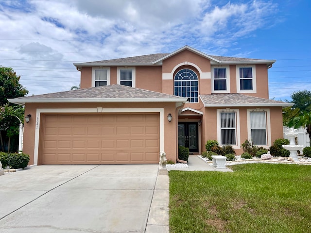 view of front of property with a garage and a front lawn