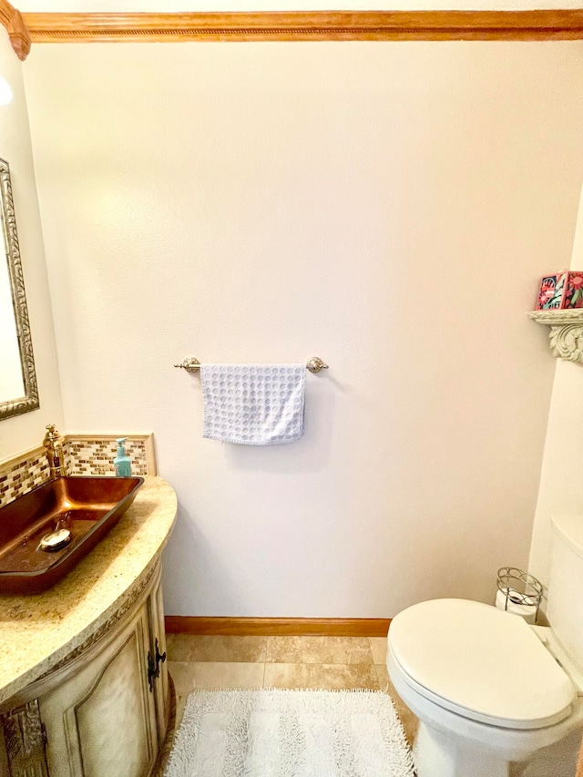 bathroom featuring toilet, vanity, and tile patterned floors