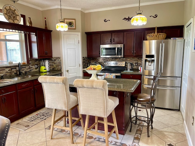 kitchen featuring sink, backsplash, appliances with stainless steel finishes, and light tile patterned floors