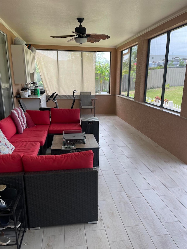 sunroom with ceiling fan