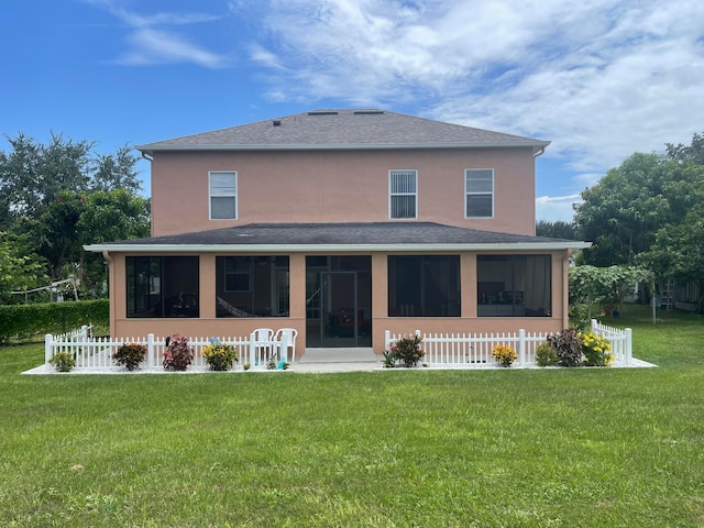 back of property featuring a sunroom and a yard