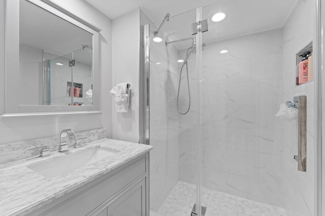 bathroom featuring vanity and a shower with shower door