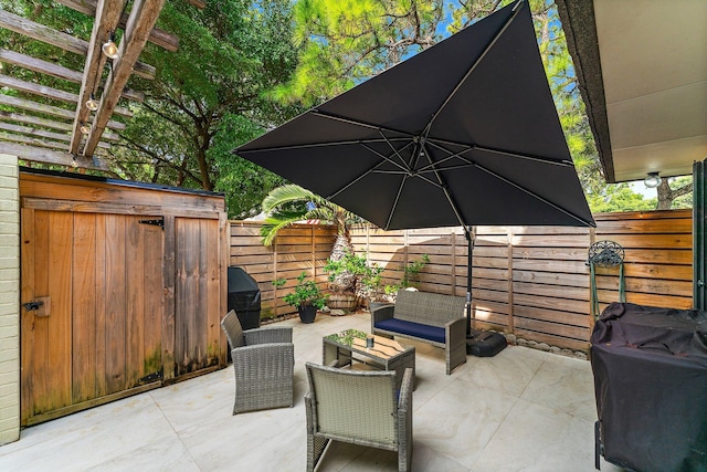 view of patio featuring a storage shed and an outdoor hangout area