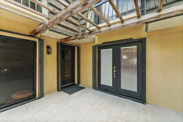 entrance to property with a patio area and french doors