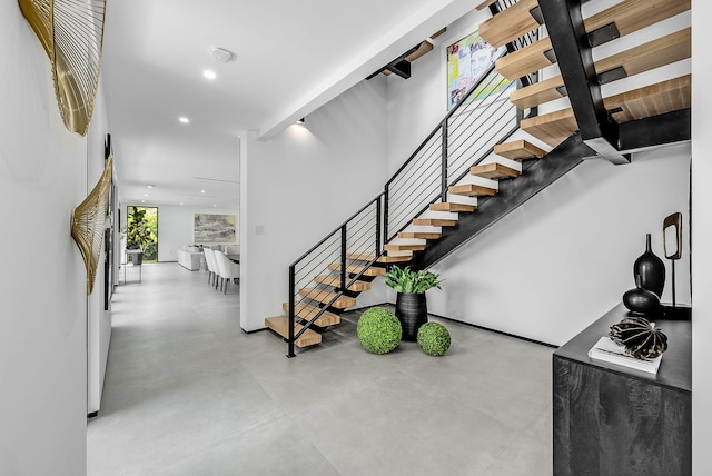 staircase with concrete floors