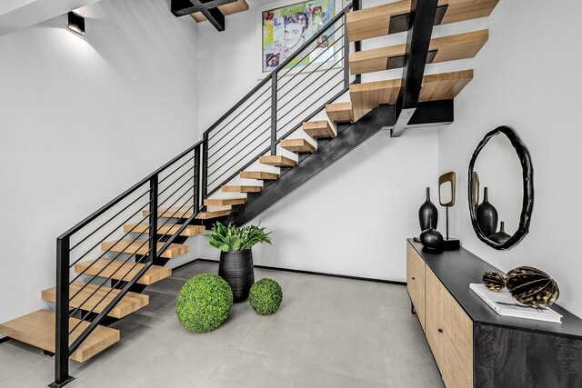 stairway featuring concrete floors