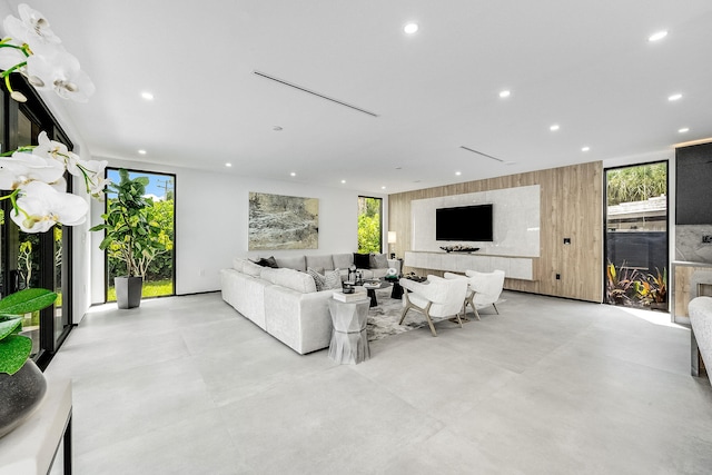 living room featuring expansive windows, a wealth of natural light, and light tile patterned flooring