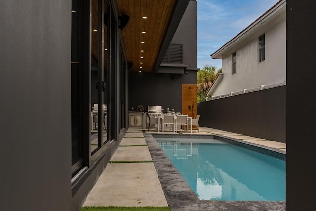 view of swimming pool with a patio area