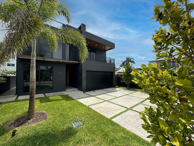 back of house featuring a garage and a lawn