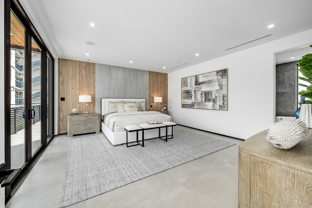 bedroom with wooden walls and access to outside