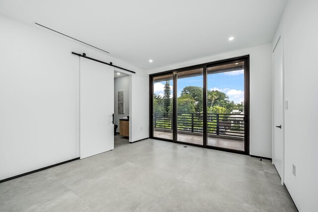 unfurnished room with a barn door