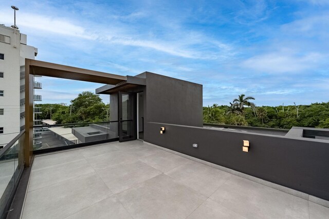 view of patio featuring a balcony