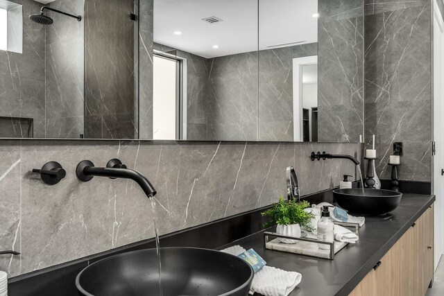 bathroom featuring tile walls, tasteful backsplash, and vanity