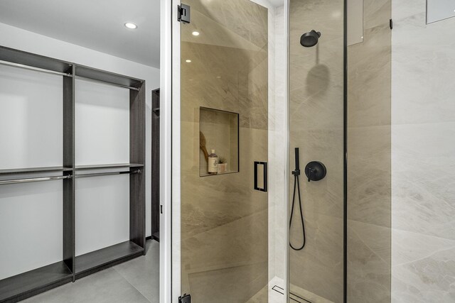 bathroom featuring a shower with door and tile patterned floors