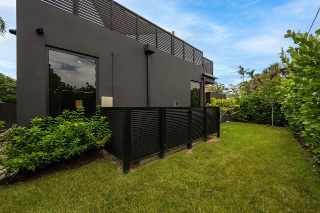 view of side of home with a lawn