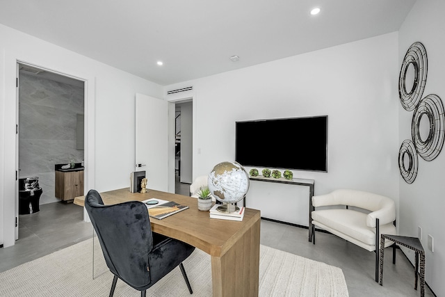 office area with tile walls and concrete floors