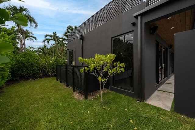 view of side of home featuring a yard