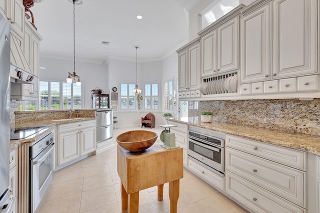 kitchen with light tile patterned floors, stainless steel oven, tasteful backsplash, and light stone counters