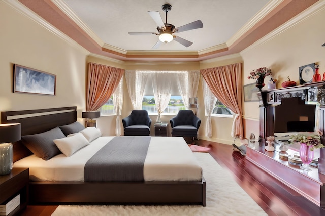 bedroom featuring ceiling fan, ornamental molding, and wood-type flooring