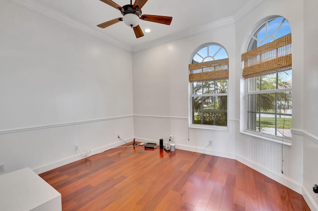 empty room with ceiling fan, crown molding, and dark hardwood / wood-style flooring