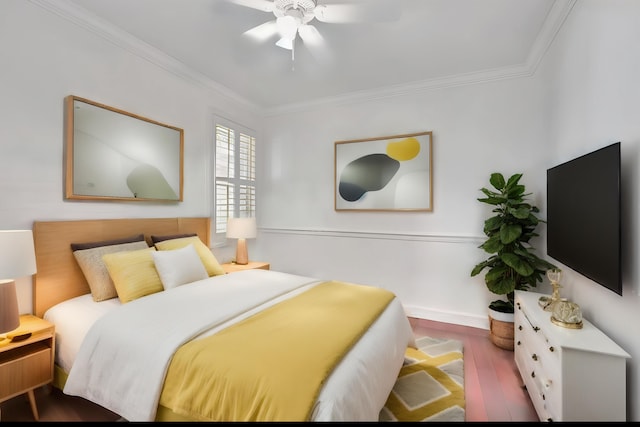 bedroom featuring ceiling fan, ornamental molding, and wood-type flooring