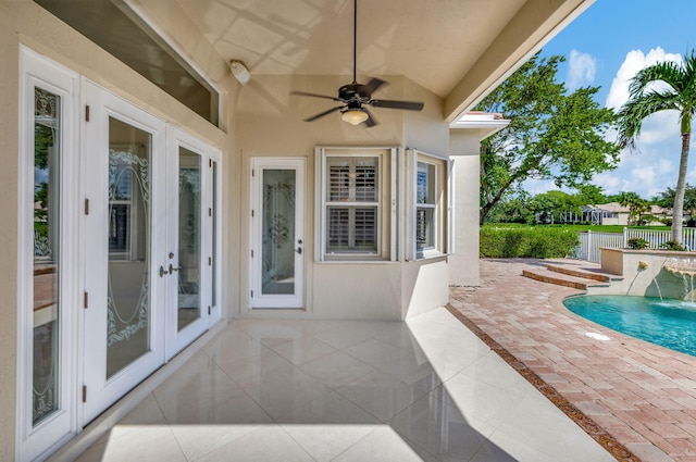 view of patio / terrace featuring ceiling fan, french doors, and pool water feature