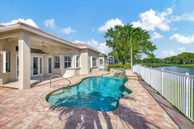 view of pool featuring ceiling fan, a water view, a patio area, and pool water feature