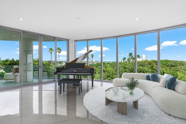 living room with expansive windows and light tile patterned flooring