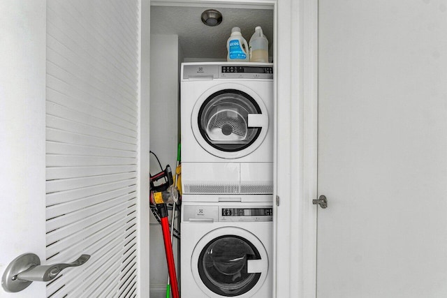 washroom with stacked washer / dryer