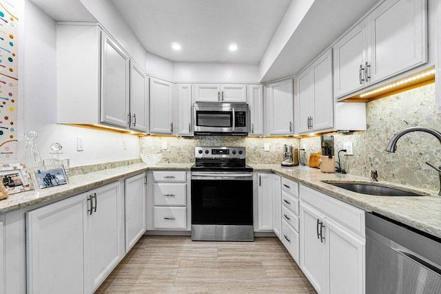 kitchen featuring sink, white cabinets, and stainless steel appliances