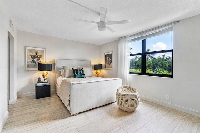 bedroom featuring ceiling fan and a textured ceiling