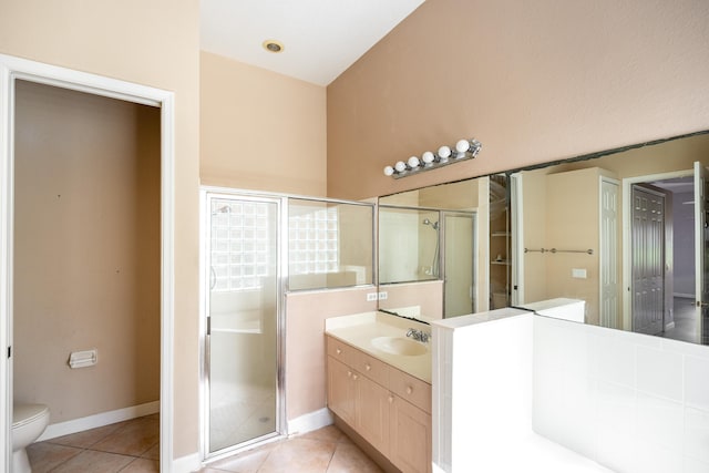 bathroom with tile patterned floors, a stall shower, toilet, and vanity