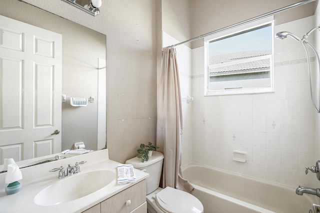 full bathroom with vanity, toilet, and shower / tub combo