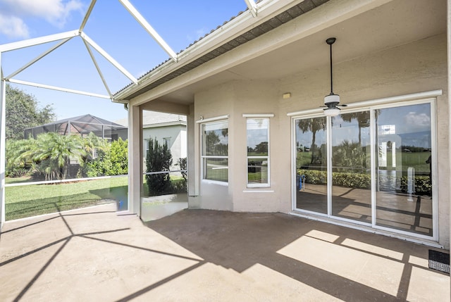 unfurnished sunroom featuring ceiling fan