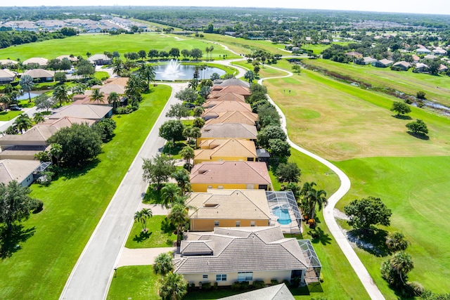 birds eye view of property featuring view of golf course, a residential view, and a water view