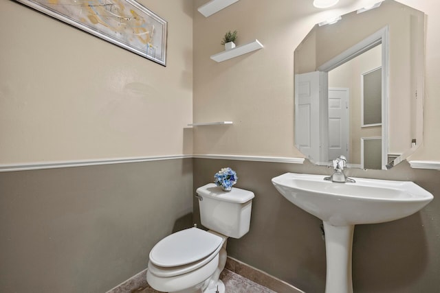 bathroom with tile patterned flooring and toilet