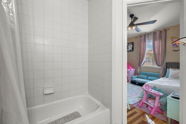 bathroom featuring ceiling fan, shower / bath combination with curtain, and hardwood / wood-style floors