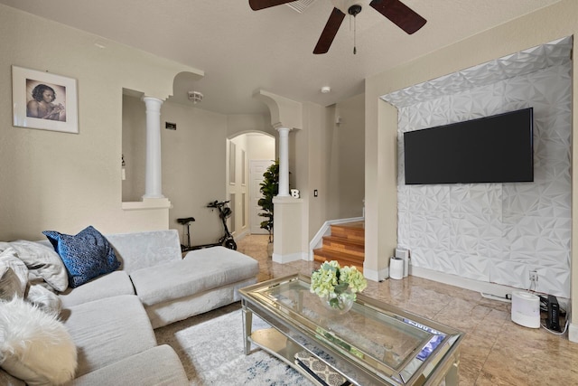 living room featuring ceiling fan, light tile patterned floors, and decorative columns