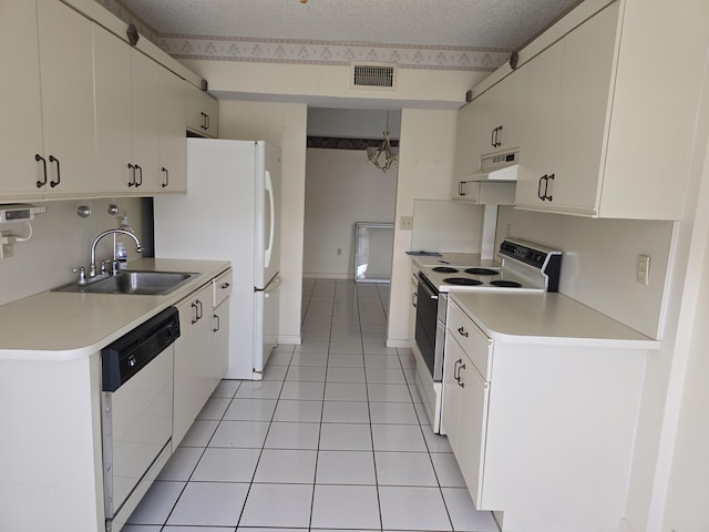 kitchen featuring white cabinets, white appliances, light countertops, and a sink