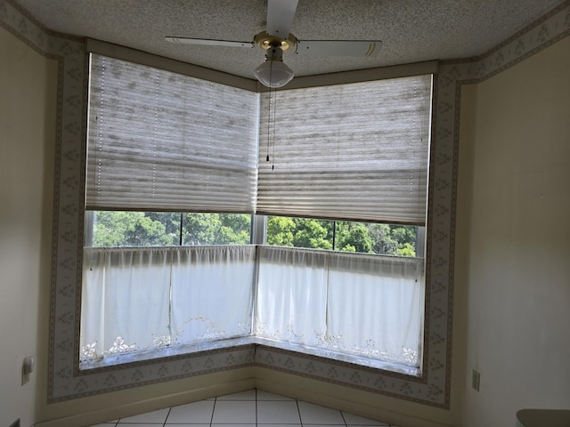 interior space featuring a textured ceiling and ceiling fan