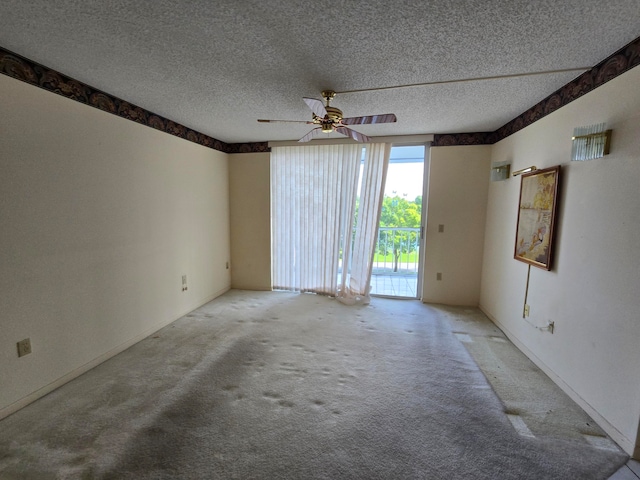 empty room featuring a textured ceiling, carpet flooring, and ceiling fan