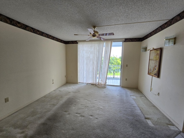 empty room with a textured ceiling, ceiling fan, and carpet flooring