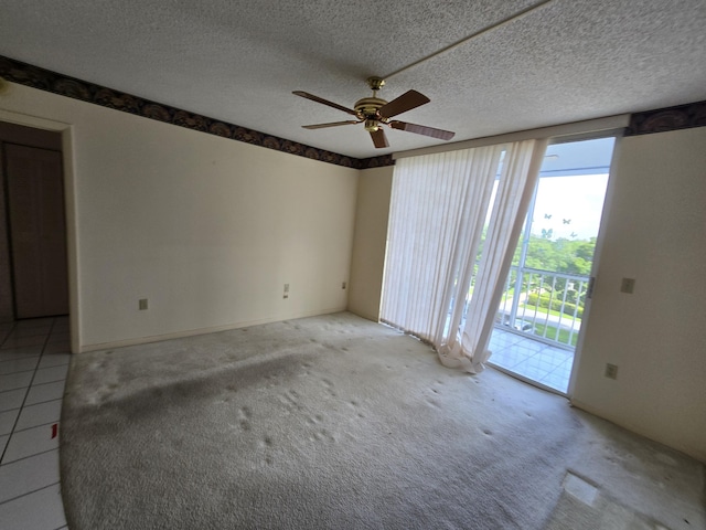 unfurnished room featuring a ceiling fan, a textured ceiling, and light colored carpet