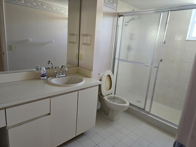 bathroom with toilet, tile patterned floors, a shower stall, and vanity