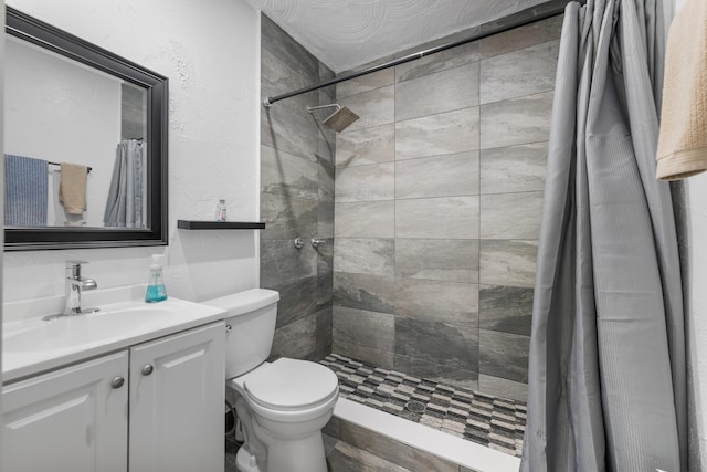 bathroom featuring a shower with curtain, vanity, and toilet