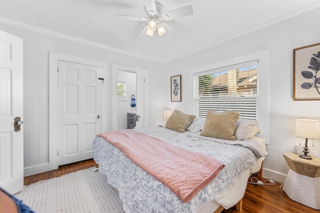 bedroom featuring hardwood / wood-style flooring, ceiling fan, and ornamental molding