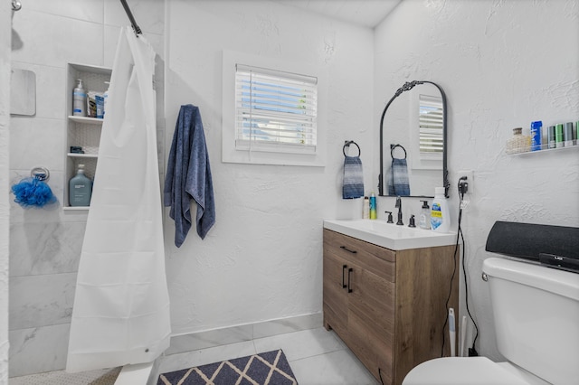 bathroom featuring a healthy amount of sunlight, toilet, tile patterned flooring, and vanity