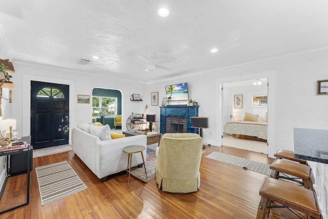 living room with light hardwood / wood-style floors and ceiling fan