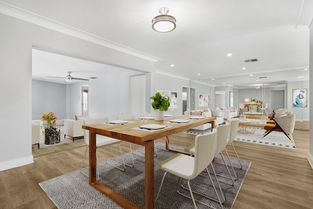 dining space featuring ornamental molding, hardwood / wood-style floors, and ceiling fan